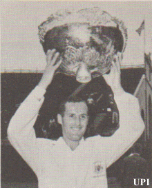 Neale Fraser hoists the Davis Cup