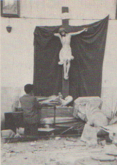 Valdivian man praying in a damaged church